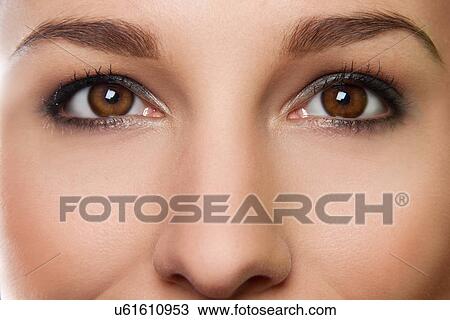 Stock Image - Cropped studio portrait of young woman's eyes. Fotosearch