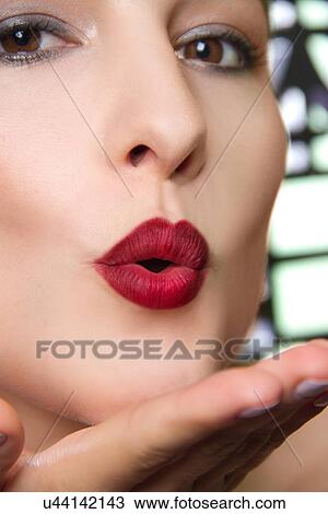Cropped studio portrait of young woman blowing a kiss View Large Photo Image Stock Image - Cropped studio portrait of young woman blowing a kiss. Fotosearch