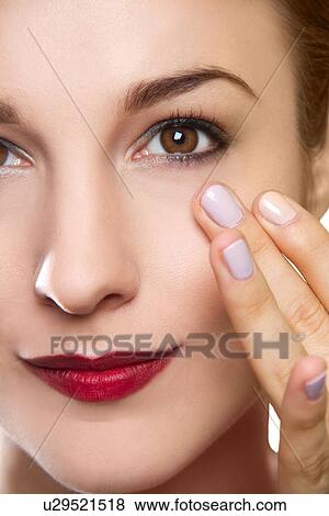 Cropped studio portrait of young woman touching her face View Large Photo Image Stock Photo - Cropped studio portrait of young woman touching her face. Fotosearch