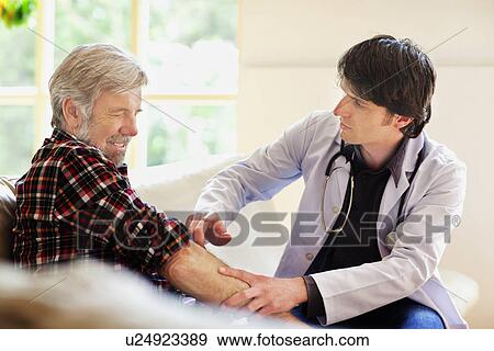 Doctor examining senior man View Large Photo Image Stock Photo - Doctor examining senior man. Fotosearch