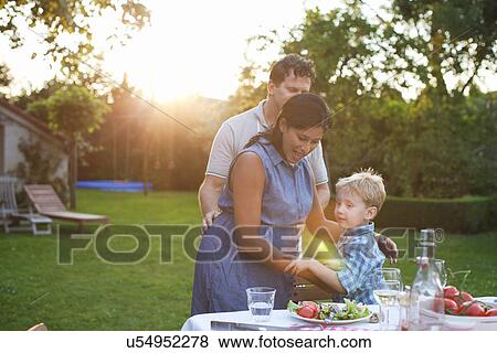 Family having dinner in garden View Large Photo Image Stock Photo - Family having dinner in garden. Fotosearch