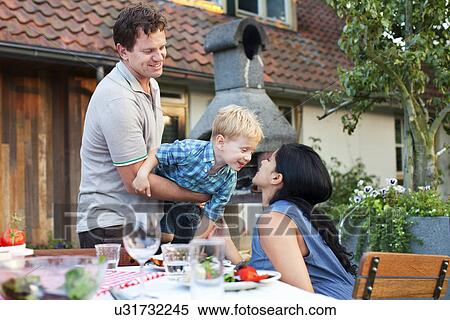 Family having dinner in garden View Large Photo Image Stock Photography - Family having dinner in garden. Fotosearch