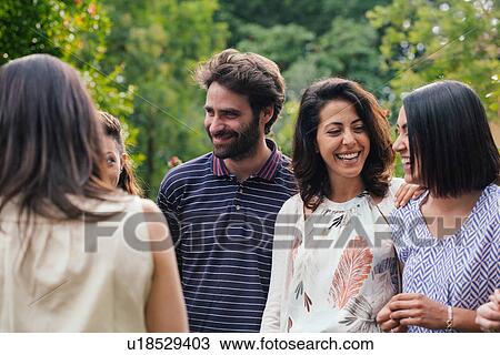 Family members talking at outdoor gathering View Large Photo Image Stock Image - Family members talking at outdoor gathering. Fotosearch