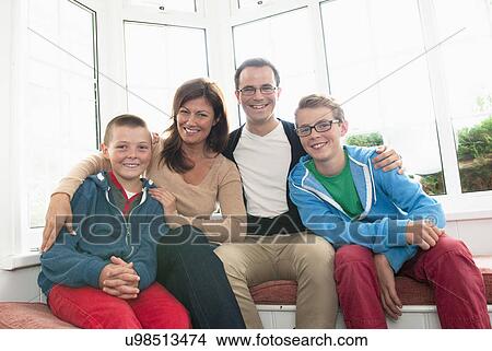 Family portrait in front of window View Large Photo Image Picture - Family portrait in front of window. Fotosearch