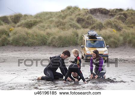 Family with two boys playing on beach View Large Photo Image Stock Photography - Family with two boys playing on beach. Fotosearch