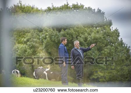 Farmer and son discussing in field View Large Photo Image Stock Image - Farmer and son discussing in field. Fotosearch