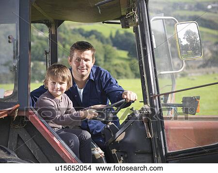 Farmer and young son in tractor in field, portrait View Large Photo Image Picture - Farmer and young son in tractor in field, portrait. Fotosearch