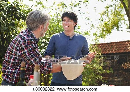 Father and adult son making pizza dough View Large Photo Image Stock Image - Father and adult son making pizza dough. Fotosearch