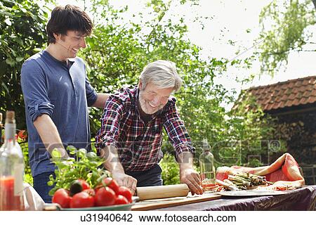Father and adult son making pizza View Large Photo Image Stock Image - Father and adult son making pizza. Fotosearch
