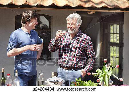 Father and adult son outside with drinks View Large Photo Image Picture - Father and adult son outside with drinks. Fotosearch
