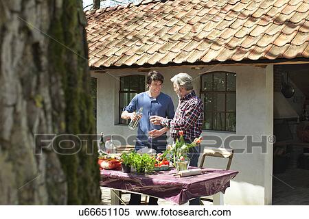 Father and adult son outside with drinks View Large Photo Image Stock Photography - Father and adult son outside with drinks. Fotosearch
