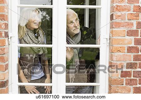 Father and daughter looking through window View Large Photo Image Stock Image - Father and daughter looking through window. Fotosearch