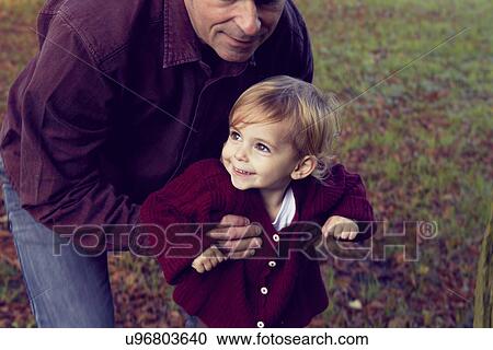 Father and daughter walking through forest View Large Photo Image Stock Image - Father and daughter walking through forest. Fotosearch