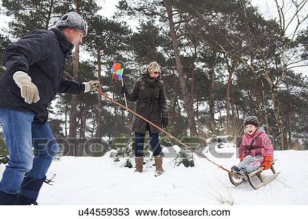 Father and grandmother pulling girl on toboggan in snow View Large Photo Image Stock Image - Father and grandmother pulling girl on toboggan in snow. Fotosearch
