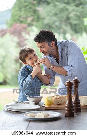 Father and son eating bread View Large Photo Image Picture - Father and son eating bread. Fotosearch