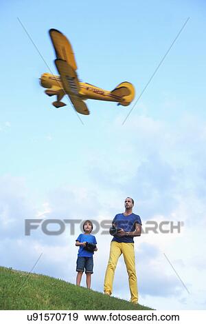 Father and son flying model plane View Large Photo Image Stock Photo - Father and son flying model plane. Fotosearch