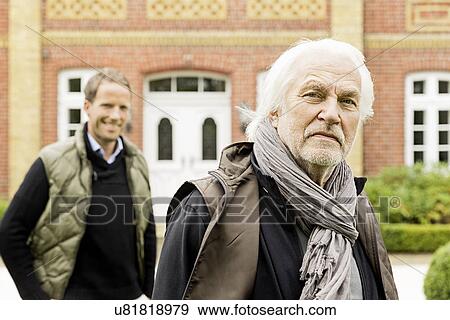 Stock Photo - Father and son in front of house. Fotosearch