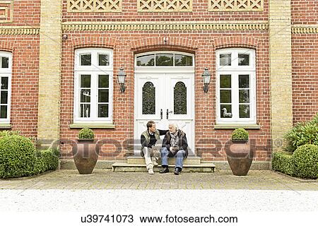 Father and son sitting on doorstep View Large Photo Image Stock Image - Father and son sitting on doorstep. Fotosearch
