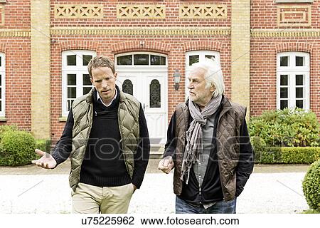 Father and son walking in front of house View Large Photo Image Stock Image - Father and son walking in front of house. Fotosearch
