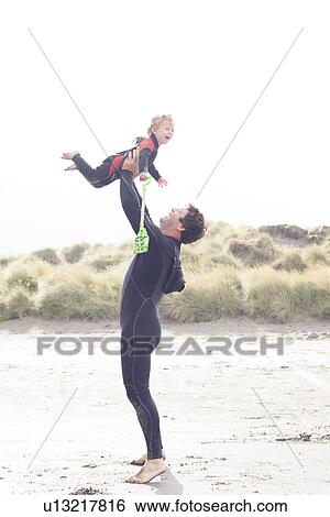 Father lifting son on beach View Large Photo Image Stock Photograph - Father lifting son on beach. Fotosearch