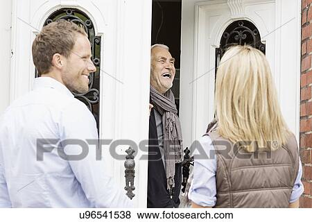 Father opening front door laughing View Large Photo Image Stock Photo - Father opening front door laughing. Fotosearch