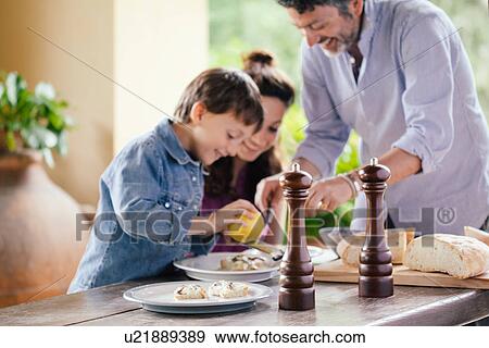 Father preparing food with son and daughter View Large Photo Image Stock Photo - Father preparing food with son and daughter. Fotosearch