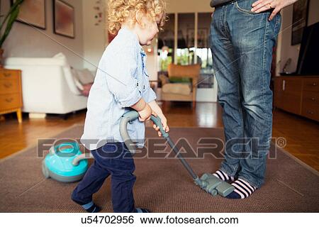 Father teasing toddler son with hoover View Large Photo Image Stock Photograph - Father teasing toddler son with hoover. Fotosearch