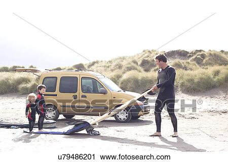 Father with two sons, surfboard and car on beach View Large Photo Image Stock Image - Father with two sons, surfboard and car on beach. Fotosearch