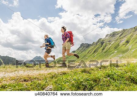 Picture - Female friends hiking, Tyrol, Austria. Fotosearch