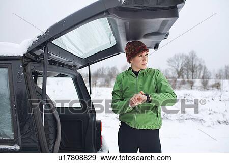 Female jogger preparing for run in snow covered scene View Large Photo Image Stock Photo - Female jogger preparing for run in snow covered scene. Fotosearch