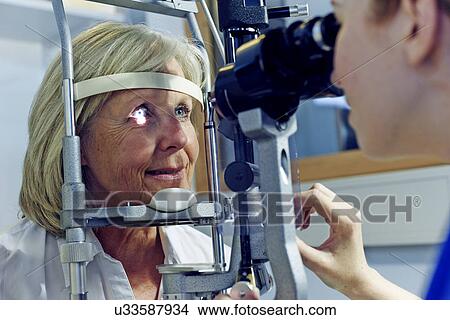 Female patient having eye tested in hospital View Large Photo Image Picture - Female patient having eye tested in hospital. Fotosearch