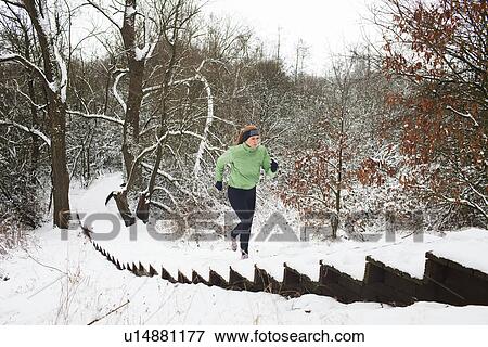 Female runner moving up snow covered staircase in winter View Large Photo Image Stock Photo - Female runner moving up snow covered staircase in winter. Fotosearch