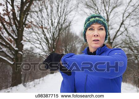 Female warming up for run in snow View Large Photo Image Stock Photography - Female warming up for run in snow. Fotosearch
