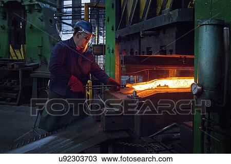 Stock Image - Flight bar is moved out of the clipping press where excess "flash" has been removed. Fotosearch
