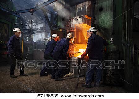 Flight bar (mining component) is manoeuvred with industrial tongs under the counterblow hammer View Large Photo Image Stock Photo - Flight bar (mining component) is manoeuvred with industrial tongs under the counterblow hammer. Fotosearch