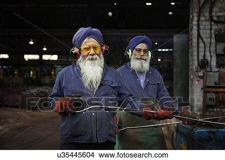 Forge workers pose whilst unloading forged components View Large Photo Image Picture - Forge workers pose whilst unloading forged components. Fotosearch