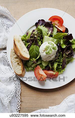 Stock Photography - Fresh mixed salad with sliced baquette. Fotosearch