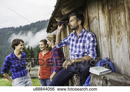 Friends chatting enjoying view through binoculars, Tirol, Austria View Large Photo Image Stock Photograph - Friends chatting enjoying view through binoculars, Tirol, Austria. Fotosearch