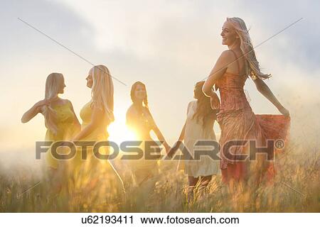 Friends dancing on meadow View Large Photo Image Stock Image - Friends dancing on meadow. Fotosearch