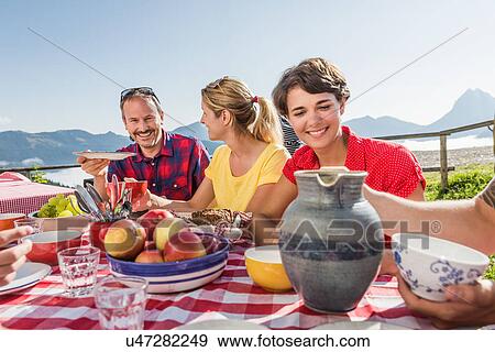 Friends enjoying breakfast, Tyrol, Austria View Large Photo Image Stock Photo - Friends enjoying breakfast, Tyrol, Austria. Fotosearch