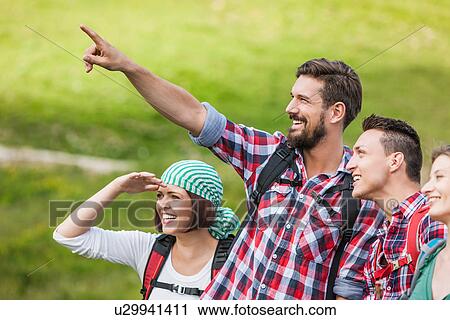 Friends on a hike, young man pointing View Large Photo Image Stock Image - Friends on a hike, young man pointing. Fotosearch