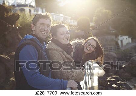 Stock Photo - Friends on day trip in Devon, UK wearing winter clothing. Fotosearch