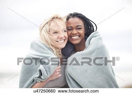 Gay couple wrapped in blanket on beach View Large Photo Image Stock Image - Gay couple wrapped in blanket on beach. Fotosearch