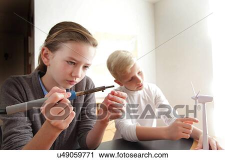 Girl and boy making a model of wind turbine View Large Photo Image Stock Image - Girl and boy making a model of wind turbine. Fotosearch