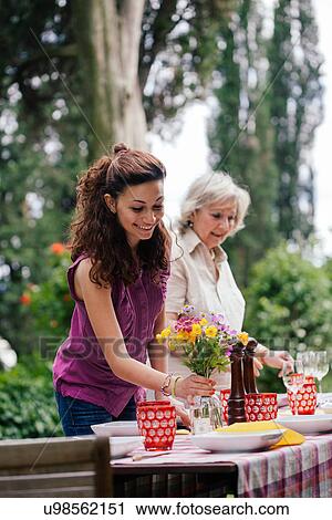 Girl and grandmother setting table for family meal View Large Photo Image Stock Image - Girl and grandmother setting table for family meal. Fotosearch
