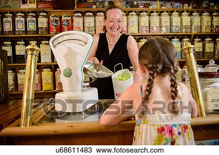 Girl buying bag of sweets from traditional sweet shop View Large Photo Image Stock Image - Girl buying bag of sweets from traditional sweet shop. Fotosearch