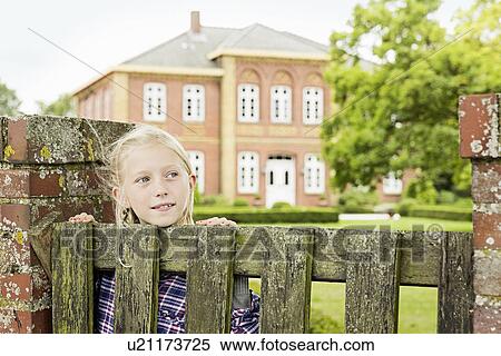 Girl by wooden gate, looking away View Large Photo Image Stock Photography - Girl by wooden gate, looking away. Fotosearch