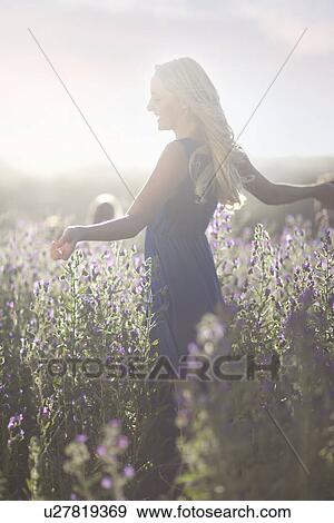 Stock Photo - Girl dancing on meadow. Fotosearch
