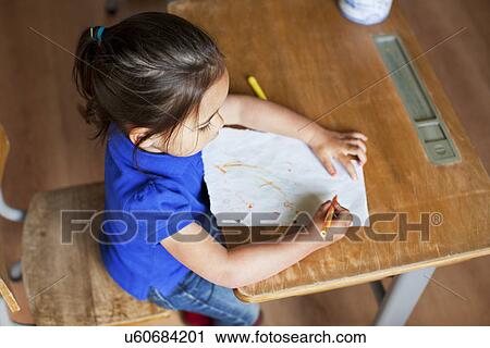 Girl drawing picture on desk, high angle View Large Photo Image Stock Image - Girl drawing picture on desk, high angle. Fotosearch