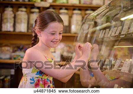 Girl looking at sweets in traditional sweet shop View Large Photo Image Stock Photography - Girl looking at sweets in traditional sweet shop. Fotosearch